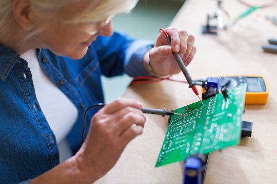 Senior woman in electronics workshop
