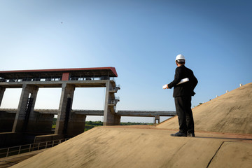 Successful man with a young engineer is watching the project.