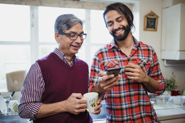 Man and Father Looking at Smartphone Together