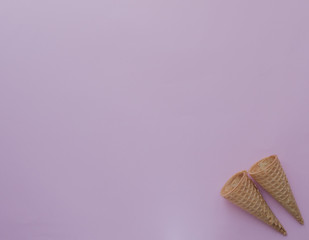 Ice cream cones on pink background with copy space