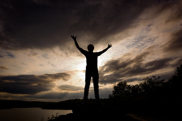 Silhouette Tourist man open arm. He is happy in the mountain. Tourism concept.