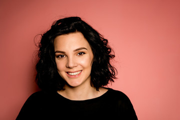 Young women on pink background