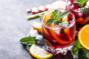 Sangria with fruit, ice and mint in glass. 