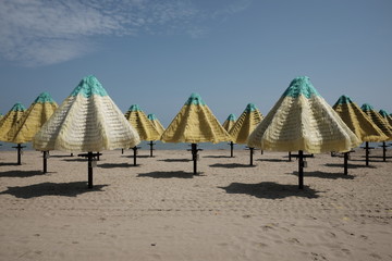 empty umbrellas on the beach of pescara