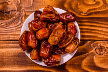 Date fruits on a wooden table. Top view