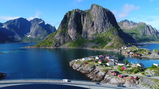 Aerial footage of small fishing village of Hamnoy on Lofoten islands in Norway, popular tourist destination with its typical red houses and natural beauty. Aerial 4k Ultra HD.