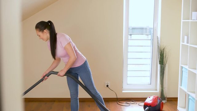household, housework and cleaning concept - happy woman or housewife with vacuum cleaner at home