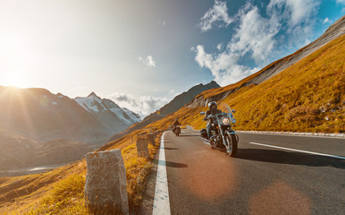 Naklejka premium Motorcycle driver riding japanese high power cruiser in Alpine highway on famous Hochalpenstrasse, Austria.
