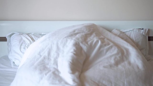 Unidentified Couple Man And Woman - Play Or Make Love Under A Large White Blanket In The Bedroom In The Morning