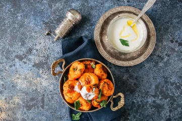 Traditional Turkish food - fellah koftes, polpettes from bulgur and semolina in tomato sauce with parsley and ayran. Middle eastern food concept.