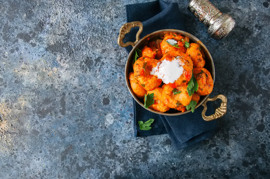 Traditional Turkish food - fellah koftes, polpettes from bulgur and semolina in tomato sauce with parsley and ayran. Middle eastern food concept.
