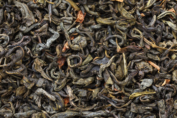 A mixture of dry green large-leaf tea with soursop
