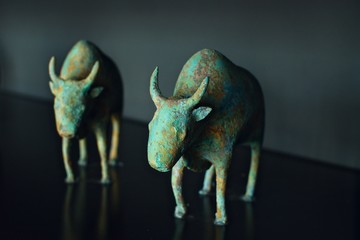 ancient Asian decoration interior oxen figurines on a dark grey background