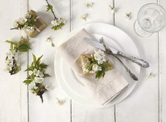 Festive spring table setting with pear blossom flowers