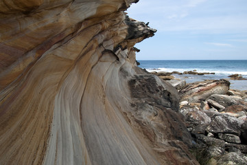 Sydney Australia, base of cliff at Marley beach in the Royal National Park looking out to sea