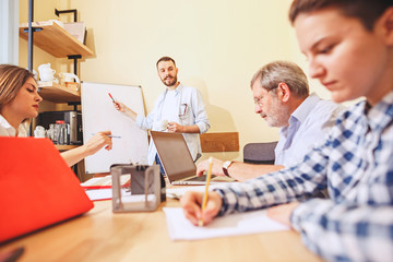 Obraz premium Team job. Photo young businessmans working with new project in office