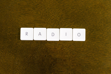 RADIO word written on plastic keyboard alphabet with dark background