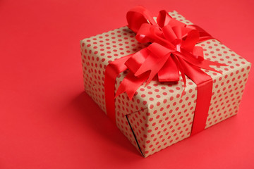 Beautifully decorated gift box on color background