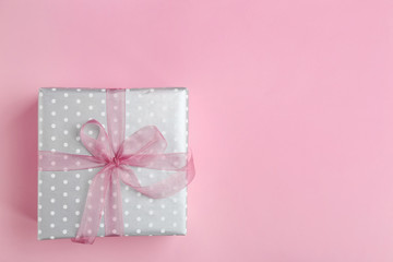 Beautifully decorated gift box on color background, top view