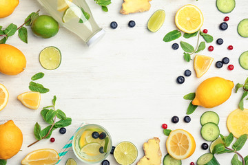 Flat lay composition with delicious natural lemonade on wooden background