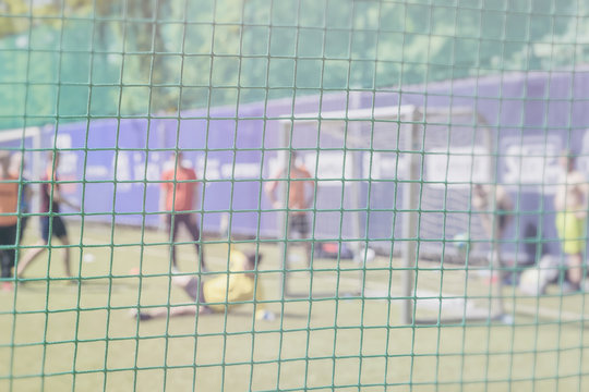 Fight for a soccer ball at the sports gate. Football training on sports field. Sportsmen, football players on training. Football outdoor stadium. Blurred image