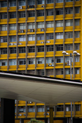 Yellow office old building with modern metallic structure in front