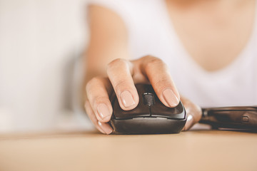 woman hand using mouse working on computer laptop in office 