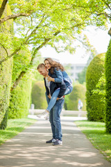 Young couple having fun in a sunny park in springtime, beautiful, romantic mood 