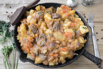 stewed vegetables with beans and meat in a frying pan