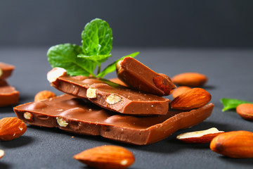 chocolate with almonds on dark grey background.