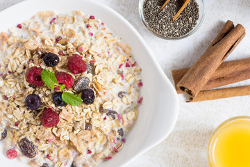 Sunny Morning with Healthy Breakfast. Muesli With Milk, Chia Seeds, Berries and Cinnamon.
