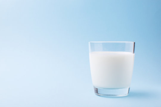 Milk in a glass on a blue background