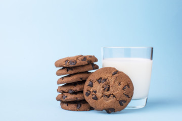glass of milk and a school chocolate biscuit on a blue background