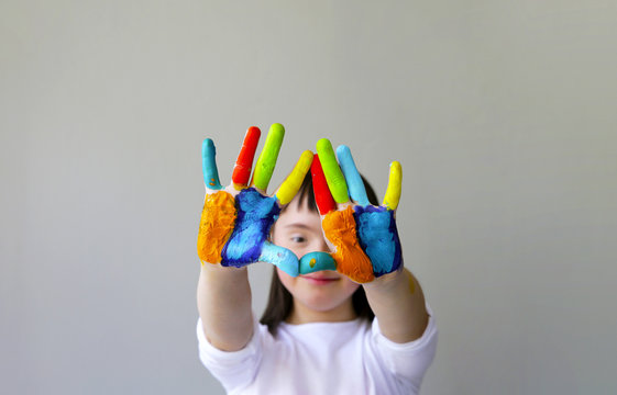 Cute little girl with painted hands.