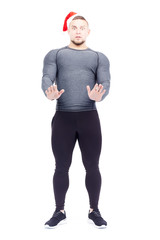 Naklejka premium Portrait of athletic man wearing sports clothes and Santa hat