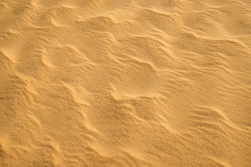 Fototapeta na wymiar Sand of a beach with waves