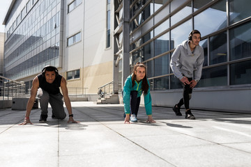 Young people go in for sports in the city. Running in the city. Friends are running around town