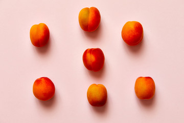 Fototapeta na wymiar Apricots set of six isolated over a pink background viewed from above, flatlay style