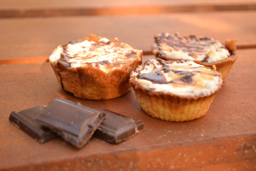 Sweet chocolate cakes on wooden table decoration