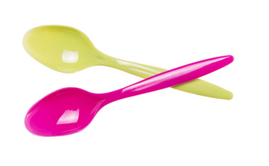 Two bright plastic disposable spoons isolated on white
