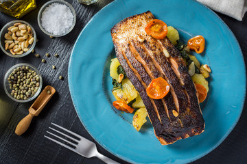 Fresh Grilled Salmon with Vegetables on Blue Plate. Healthy Meal Concept.