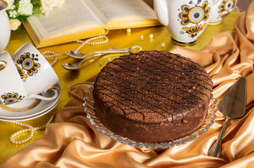 Chocolate cake tea set book and beads on fabric