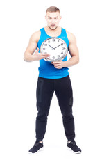 Full-length portrait of fit athlete holding wall clock on white background