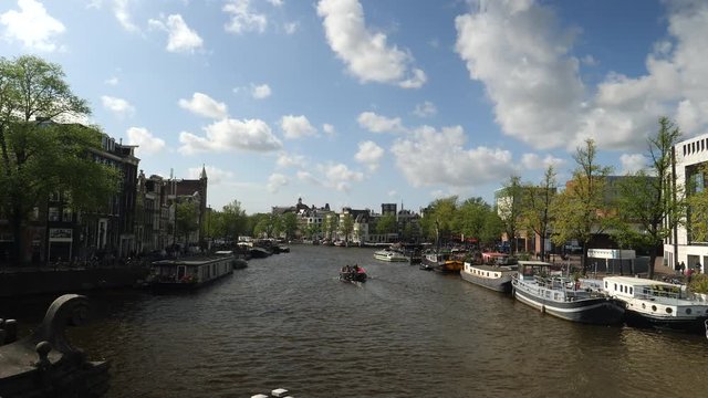 Amstel canal in Amsterdam on spectacular day, gimbal reveal shot.