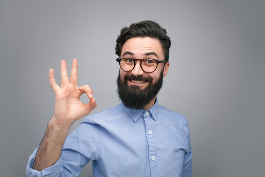 Handsome young man showing OK gesture