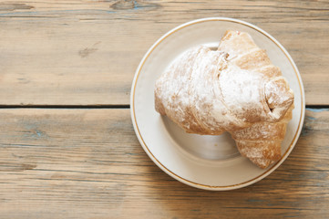 croissant bakery on teak wood table