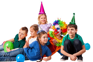Fototapeta premium Birthday child clown playing with children. Kid holiday cakes celebratory in hands of events organizer man. Fun of group people lying floor on white background. Learning in game.
