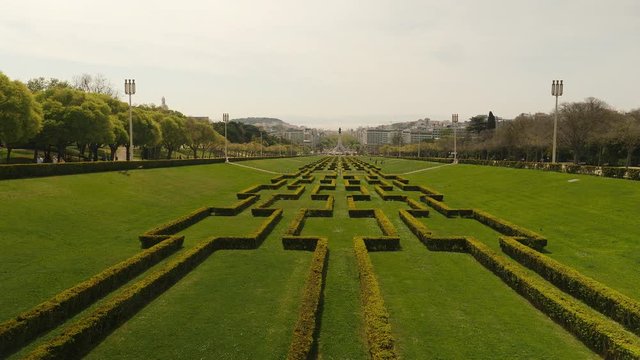 View across famous park Eduardo VII, Lisbon. Jib reveal shot.