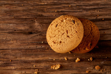 Pile of oat cookies on wooden table, close-up, selective focus.