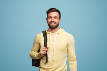 Handsome successful student on blue - obrazy, fototapety, plakaty
